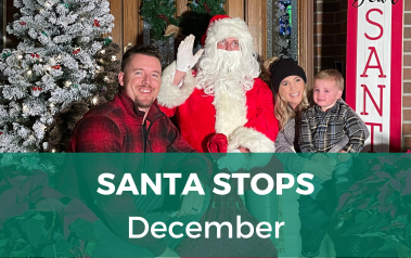 Santa Stops - December - Image of family sitting with Santa Claus on bench