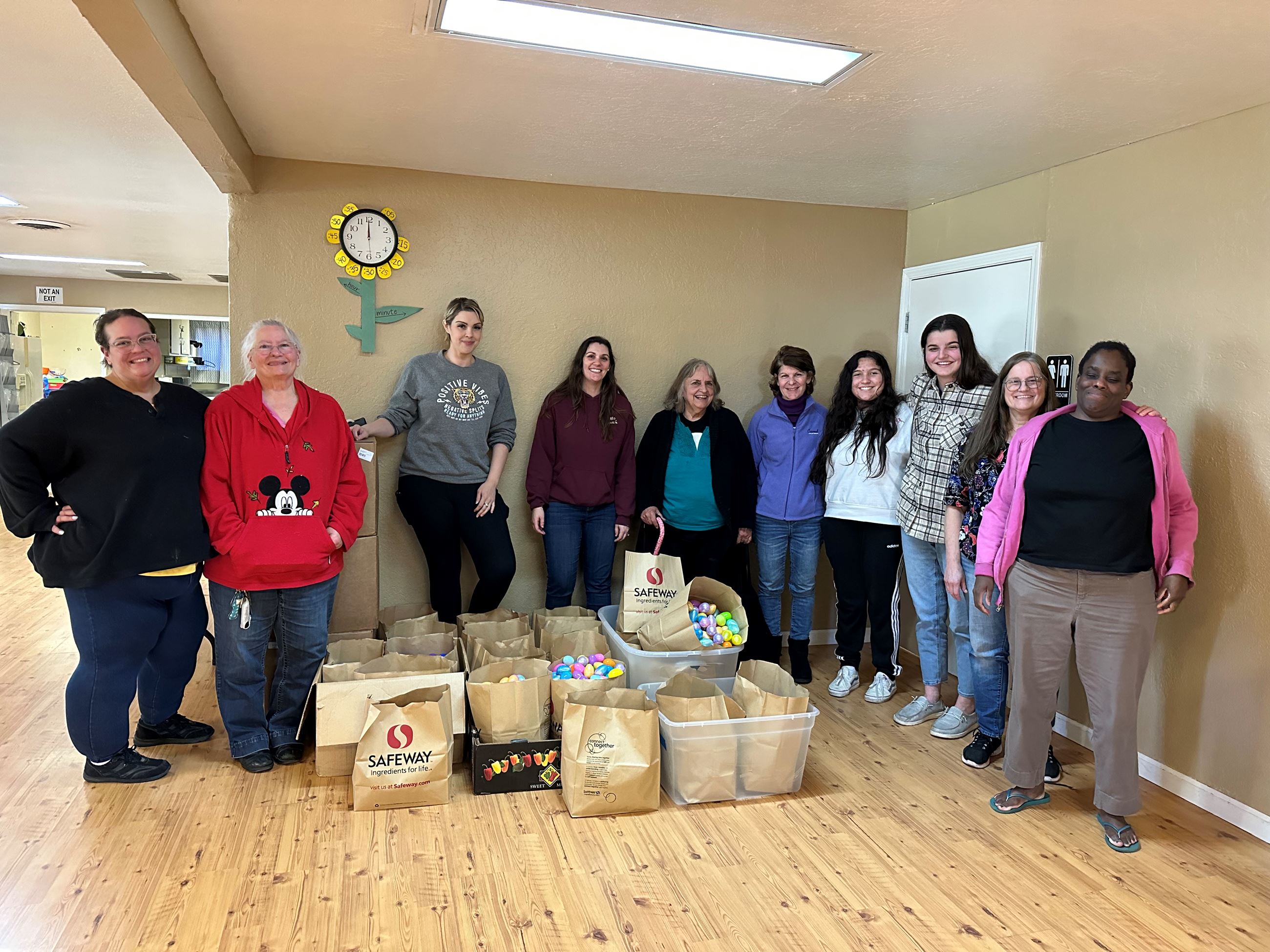 Volunteers standing in front of easter eggs 